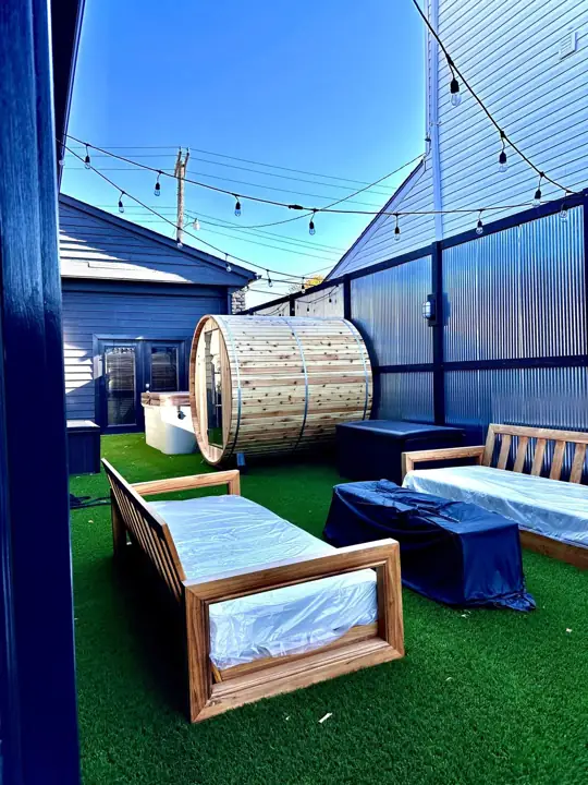 Backyard with barrel sauna, turf and string lights