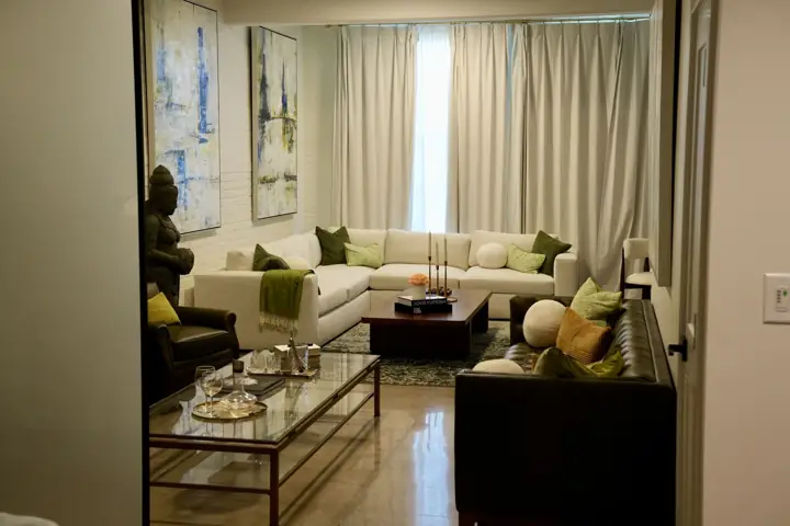 Studio living room with sectional sofa and artwork